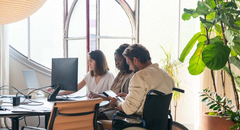 Group of people in front of a computer